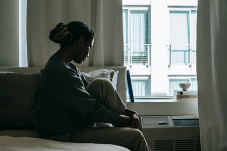 woman looking sad out window